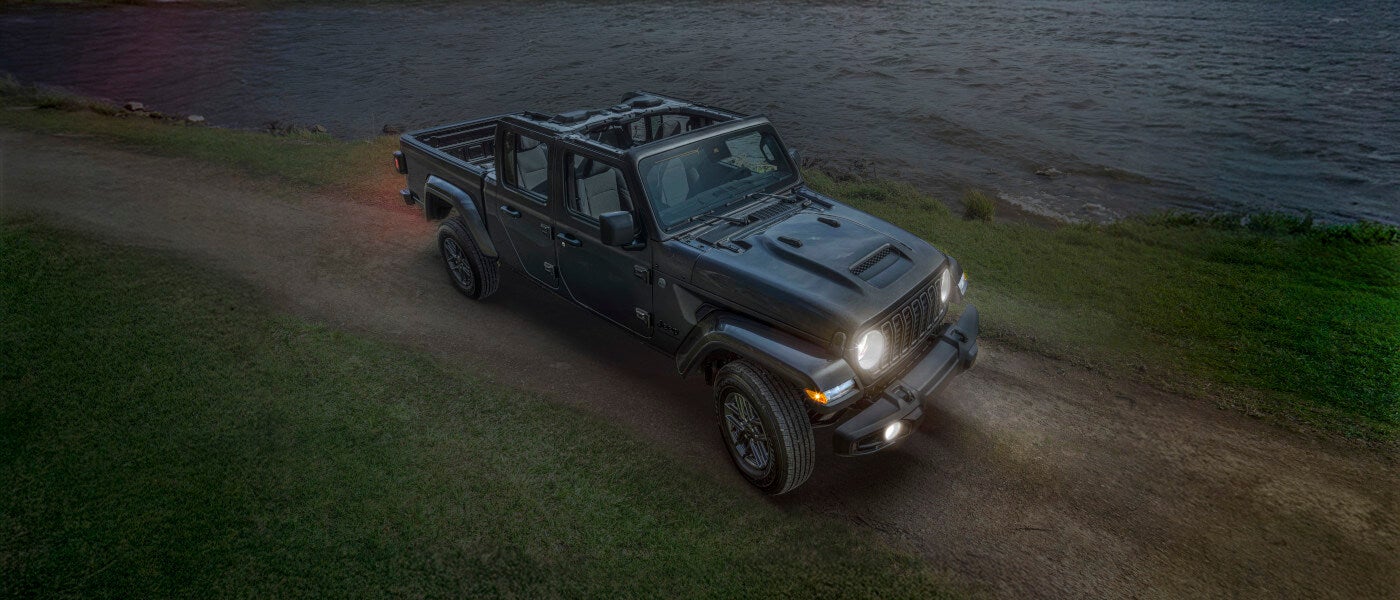 2026Jeep-Gladiator-ExteriorFromAboveNearLakeWithHeadlights